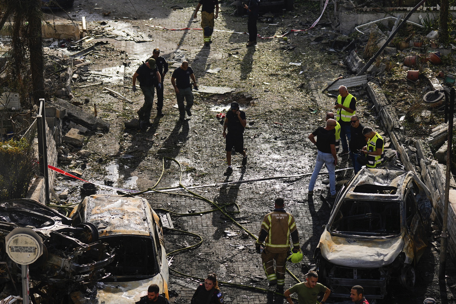 Israeli security forces examine the site hit by a rocket fired from Lebanon, in Kiryat Bialik, northern Israel, on Sunday, Sept. 22, 2024. (AP Photo