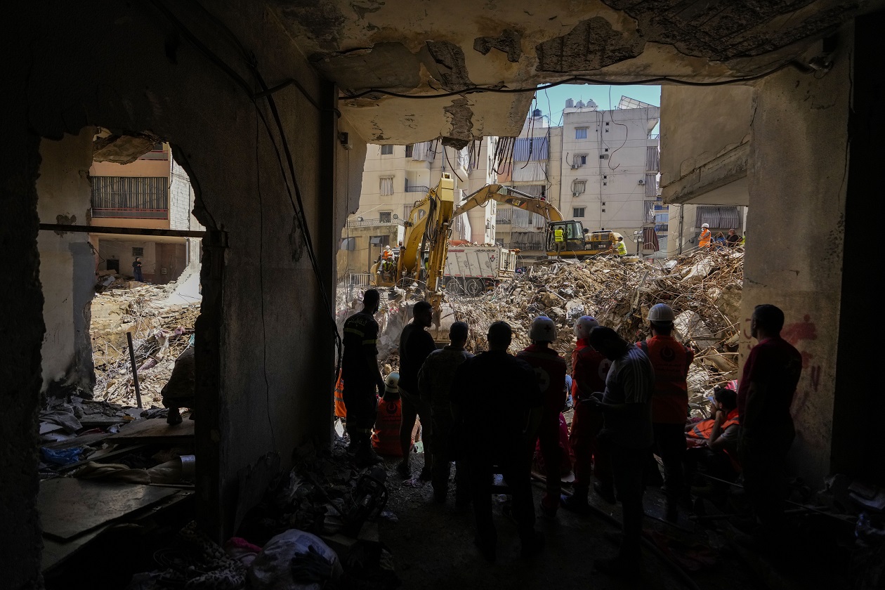 Emergency workers use excavators to clear the rubble at the site of Friday's Israeli strike in Beirut's southern suburbs, Lebanon, Monday, Sept. 23, 2024. (AP Photo