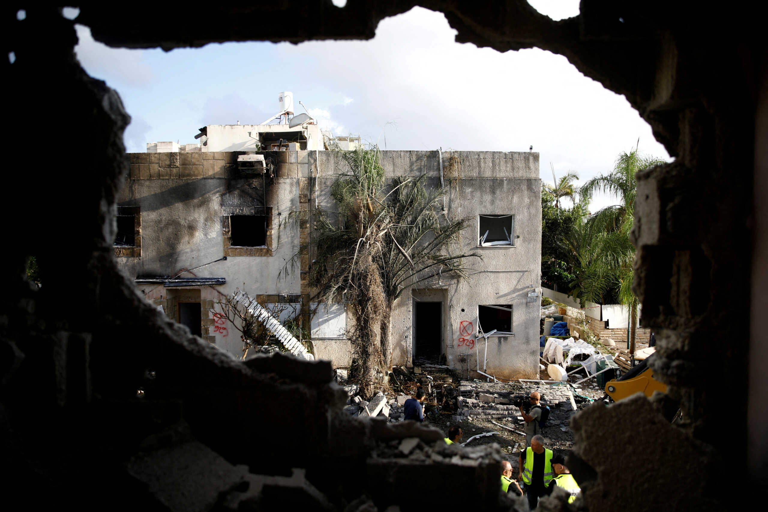 Emergency personnel work at a site of houses damaged following a rocket attack from Lebanon, amid cross-border hostilities between Hezbollah and Israel, in Kiryat Bialik, Israel, September 22, 2024. REUTERS