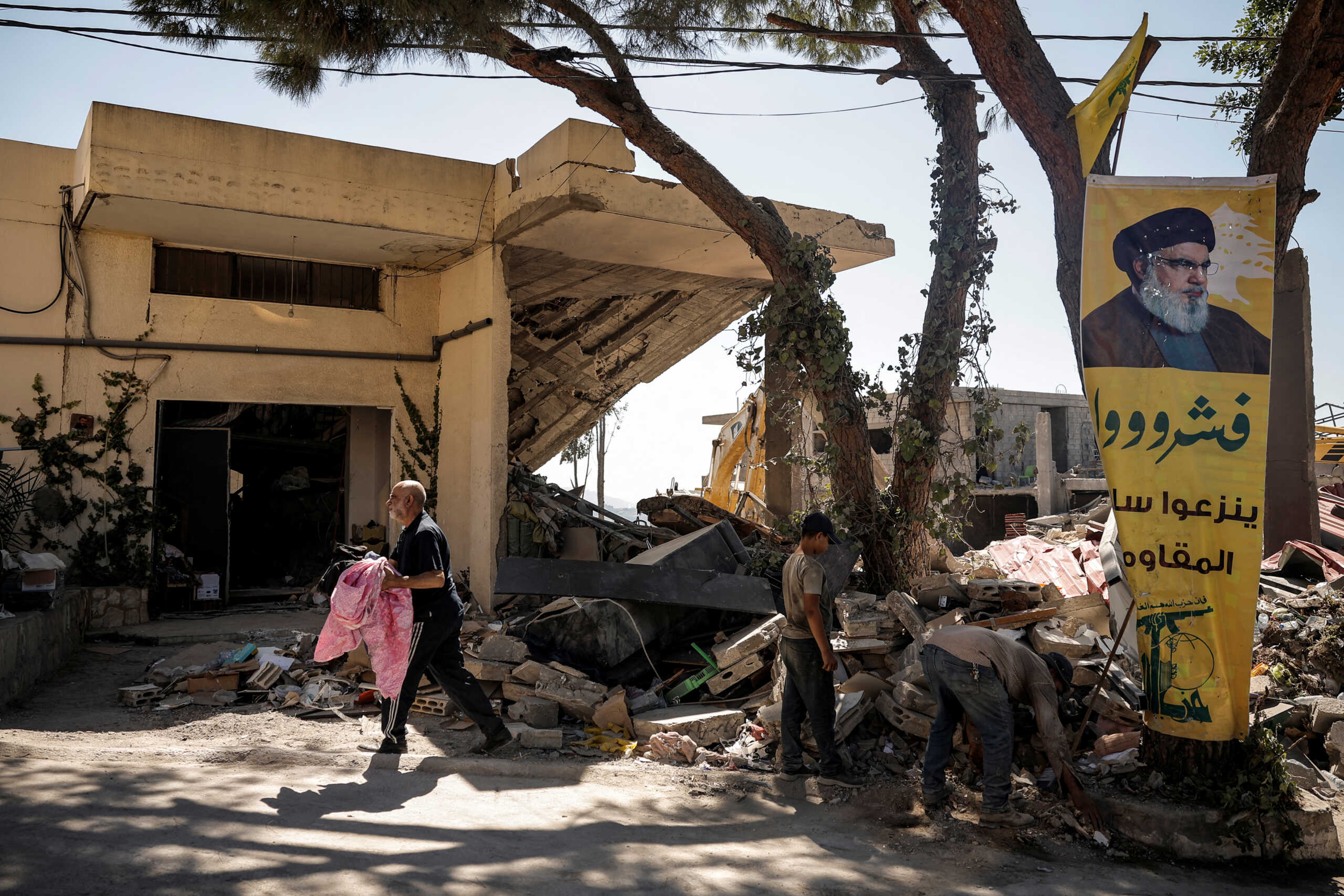 People clean debris amid ongoing search for survivors, a day after an Israeli strike on residential buildings in Maaysrah, north of Beirut, Lebanon, September 26, 2024. REUTERS
