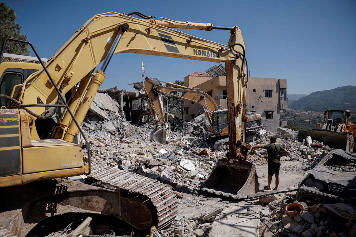 A man pauses amid ongoing search for survivors, a day after an Israeli strike on residential buildings in Maaysrah, north of Beirut, Lebanon, September 26, 2024. REUTERS
