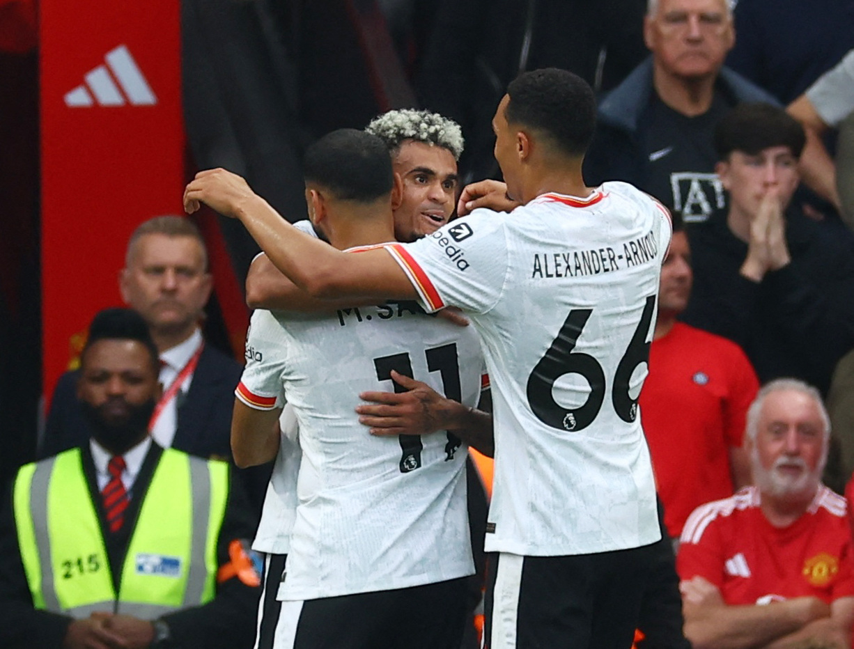 Soccer Football - Premier League - Manchester United v Liverpool - Old Trafford, Manchester, Britain - September 1, 2024 Liverpool's Luis Diaz celebrates scoring their second goal with Mohamed Salah and Trent Alexander-Arnold REUTERS