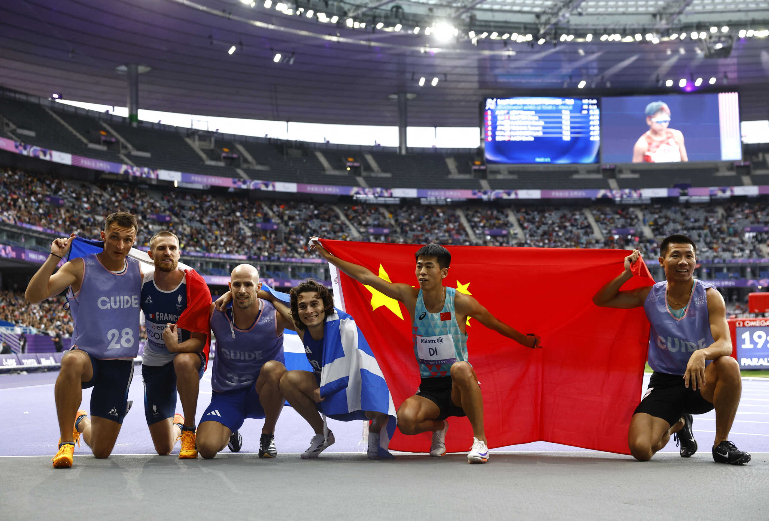 Paris 2024 Paralympics - Athletics - Men's 100m - T11 Final - Stade de France, Saint-Denis, France - September 5, 2024 Athanasios Ghavelas of Greece and guide Ioannis Nyfantopoulos celebrates after winning gold with silver medallists Timothee Adolphe of France and guide Charles Renard and bronze medallists Dongdong Di of China with guide Jiageng Lian REUTERS