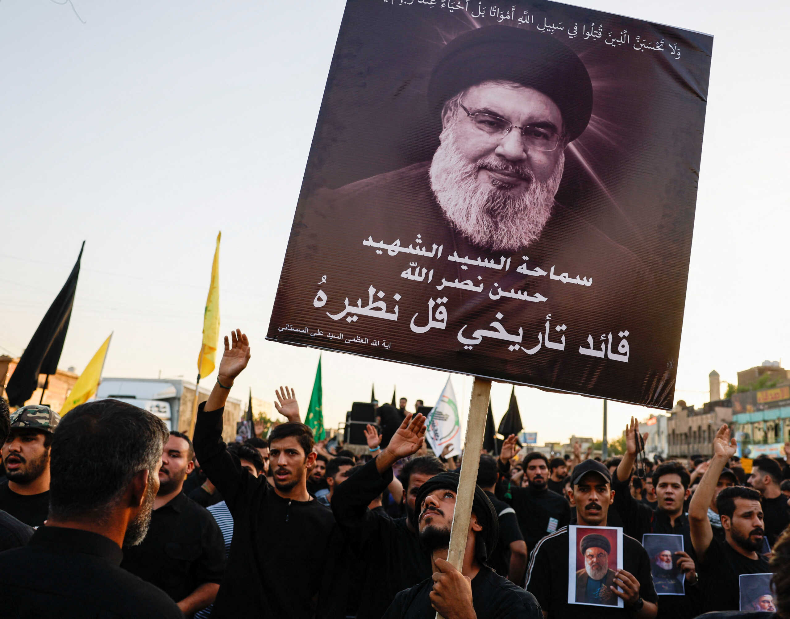 A person holds a poster of Lebanon's Hezbollah Chief Hassan Nasrallah who was killed by an Israeli airstrike in Beirut, during a symbolic funeral in Baghdad, Iraq, September 29, 2024. REUTERS