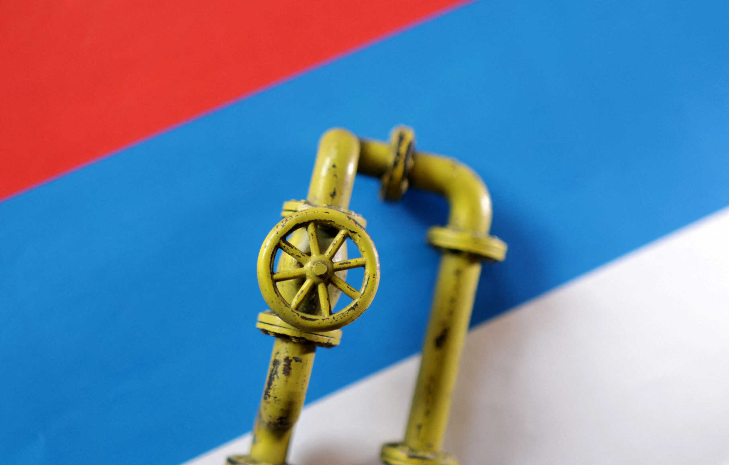 FILE PHOTO: A model of a natural gas pipeline is placed on a Russian flag in this illustration taken September 7, 2022. REUTERS