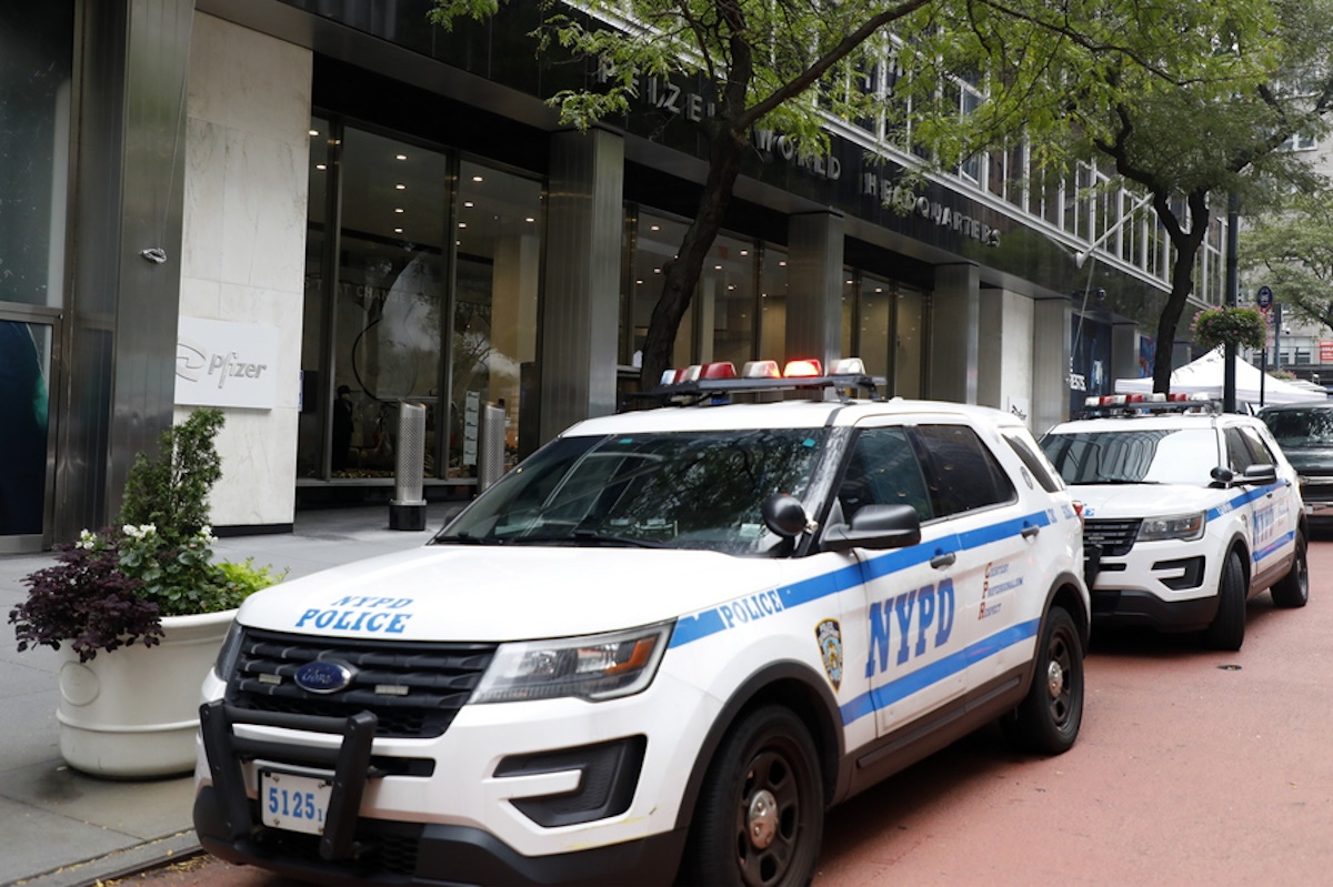 epa09473891 New York City Police Department (NYPD) cruisers are seen outside the headquarters of the pharmaceutical company Pfizer in New York, New York, USA, 17 September 2021. Vaccine advisers for the US Food and Drug Administration (FDA) are meeting on 17 September to discuss whether Americans need another booster shot of the Pfizer