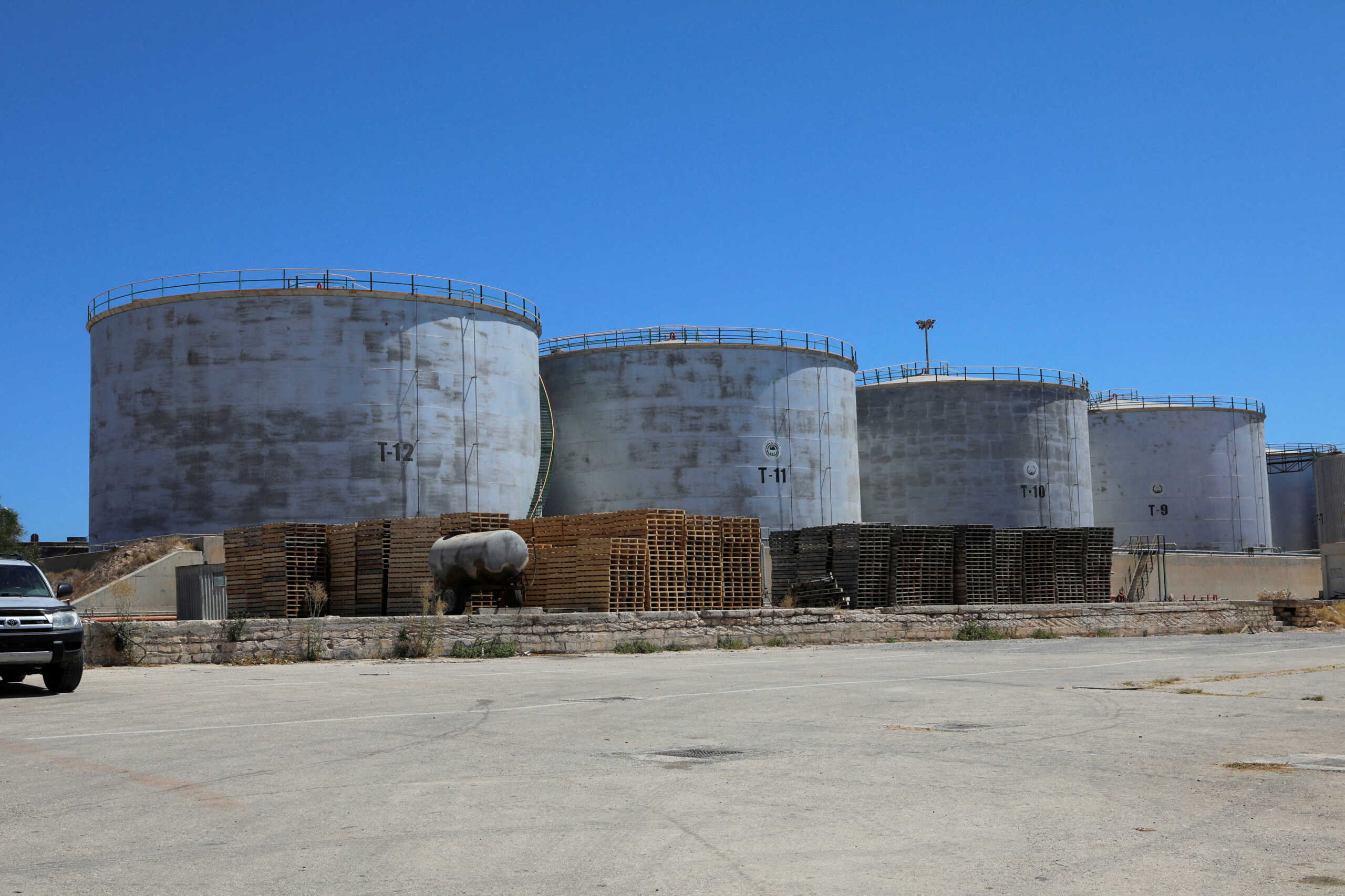 FILE PHOTO: Crude oil storage tanks are seen at Azzawiya oil refinery, in Zawiyah, west of Tripoli, Libya July 23, 2020. REUTERS