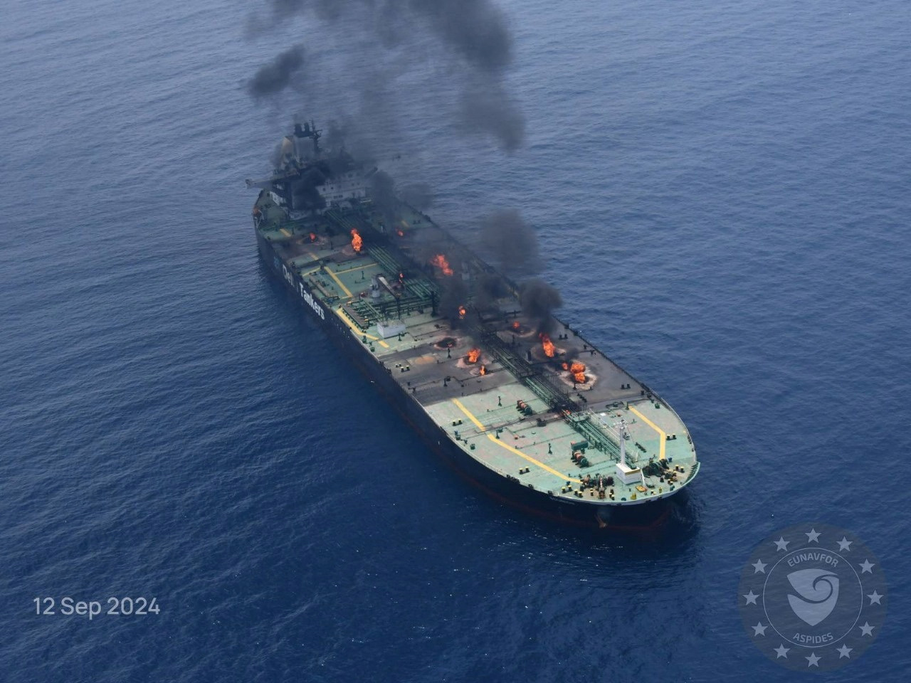 Flames and smoke rise from the Greek-flagged oil tanker Sounion, which has been on fire since August 23, after an attack by Houthi militants, on the Red Sea, September 12, 2024 in this handout image. EUNAVFOR ASPIDES