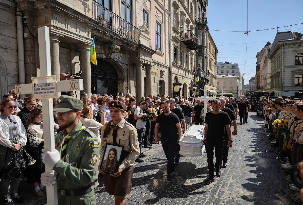 People attend a funeral procession for Yevhenia Bazylevych and her three daughters, killed during the Russian missile attack on September 4 as Yaroslav her husband, was the only survivor out of the entire family, amid Russia's attack on Ukraine, in Lviv, Ukraine September 6, 2024. REUTERS