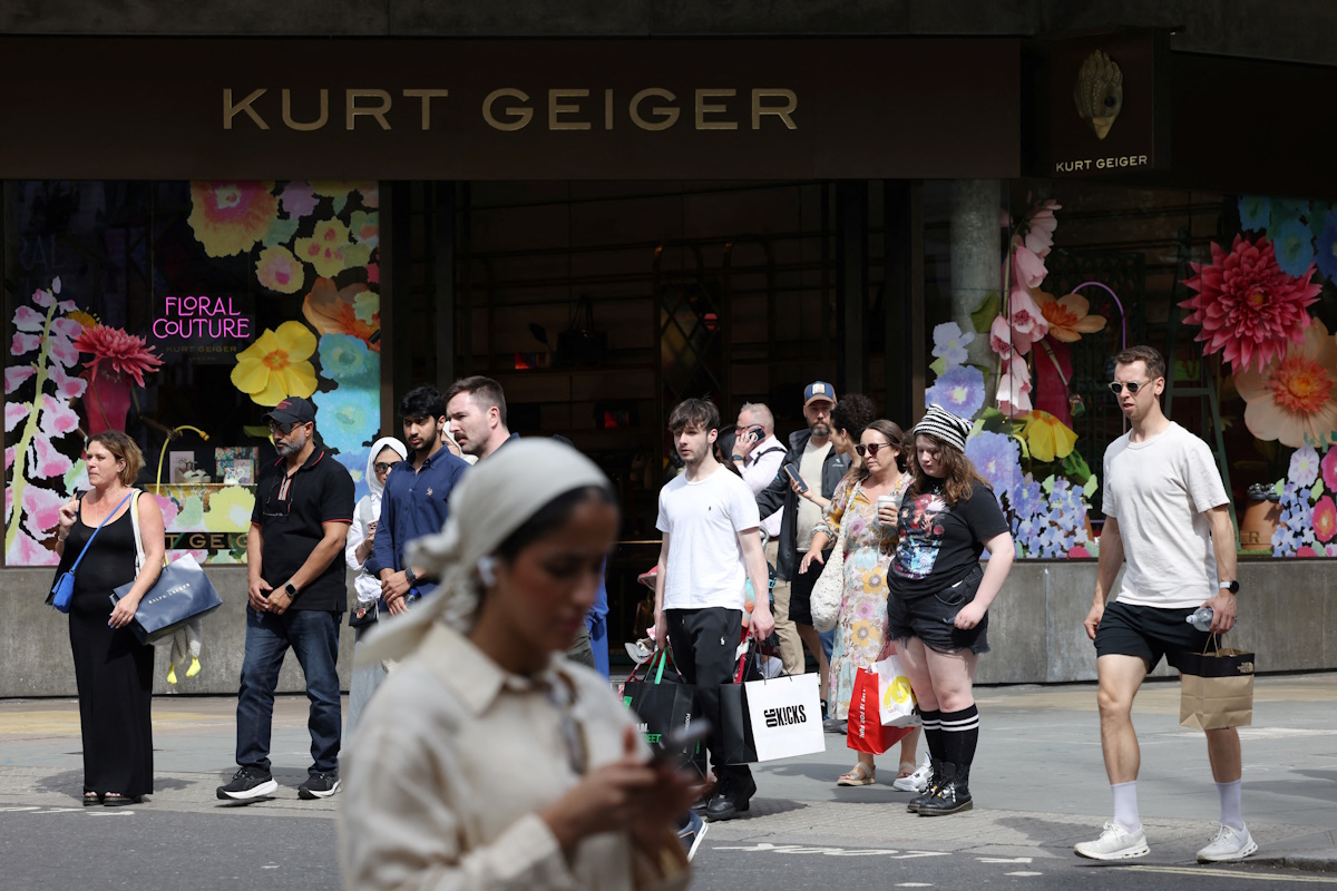 Shoppers walk past a Kurt Geiger retail store on Oxford Street in London, Britain, August 27, 2024. REUTERS