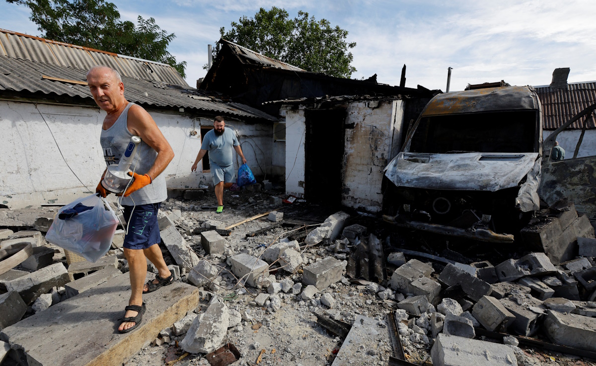 Local residents carry belongings out of a destroyed house following the shelling, which local Russian-installed authorities called a Ukrainian military strike, in the course of Russia-Ukraine conflict in Makiivka (Makeyevka) in the Donetsk region, Russian-controlled Ukraine, September 8, 2024. REUTERS