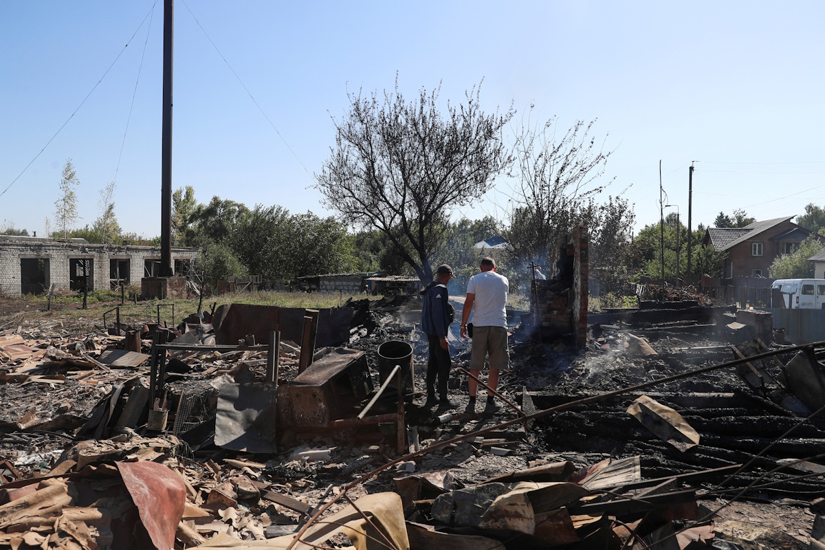 Residents stand at a site of a building destroyed by a Russian military strike, amid Russia's attack on Ukraine, in the village of Yampil, in Sumy region, Ukraine September 6, 2024. REUTERS