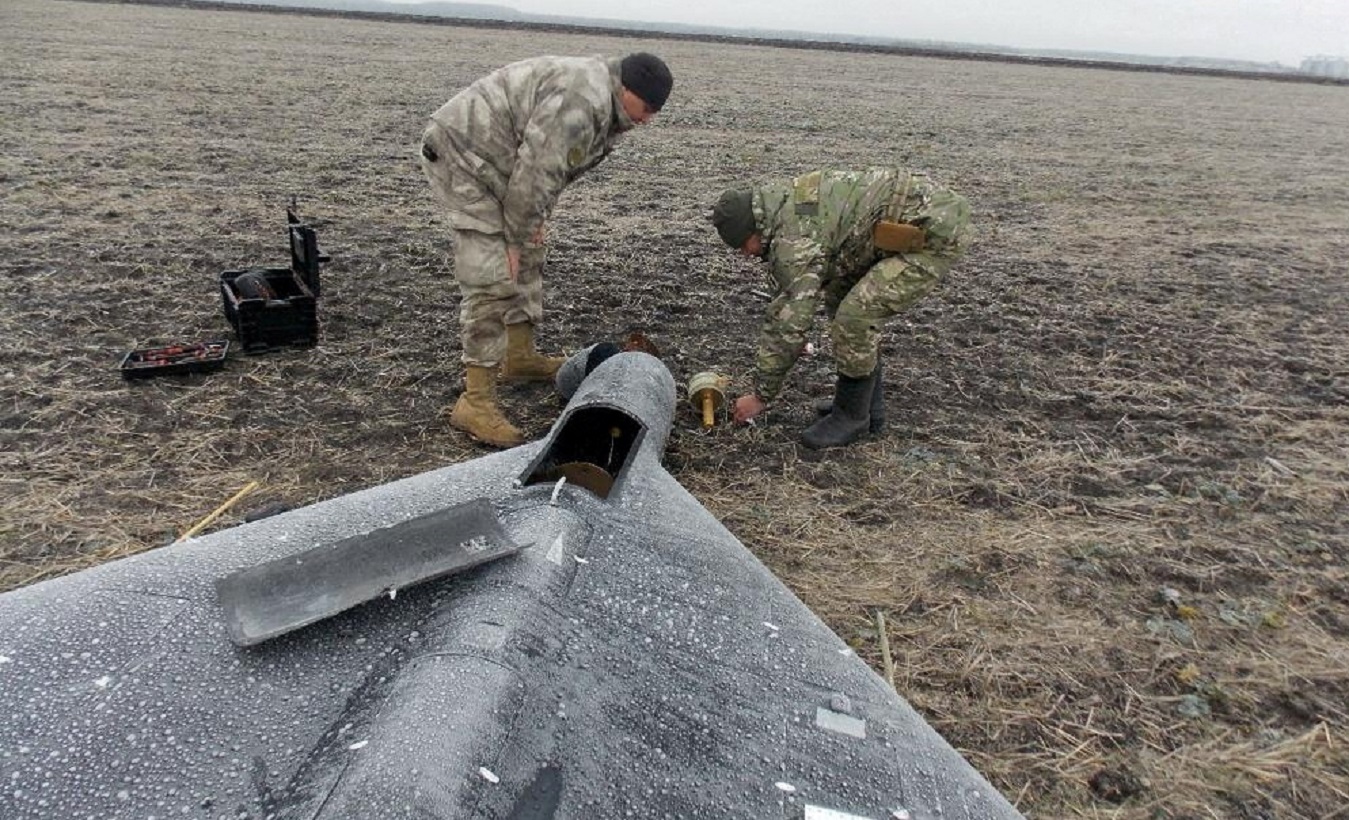 FILE PHOTO: Members of police demining unit remove a warhead from a Russian kamikaze unmanned aerial vehicle landed by a radio electronic warfare during one of latest drone strikes, amid Russia's attack on Ukraine, in an unknown location in Ukraine, in this handout picture released January 26, 2024.  Press service of the National Police of Ukraine