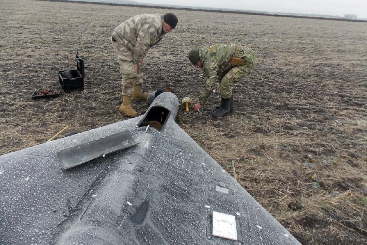 FILE PHOTO: Members of police demining unit remove a warhead from a Russian kamikaze unmanned aerial vehicle landed by a radio electronic warfare during one of latest drone strikes, amid Russia's attack on Ukraine, in an unknown location in Ukraine, in this handout picture released January 26, 2024.  Press service of the National Police of Ukraine