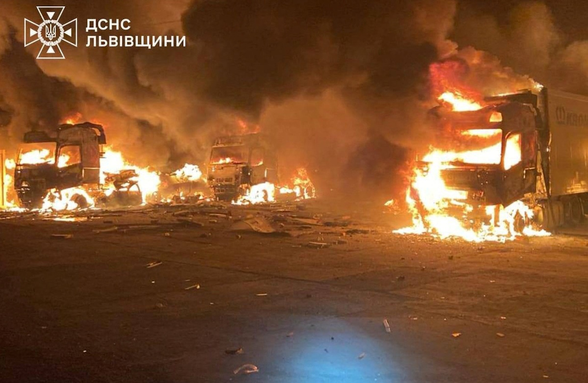 Fire and smoke rise from burning trucks at a site where warehouse facilities were hit during a Russian drone strike, amid Russia's attack on Ukraine, in the village of Murovane, outside of Lviv, Ukraine September 6, 2024. Press service of the State Emergency Service of Ukraine