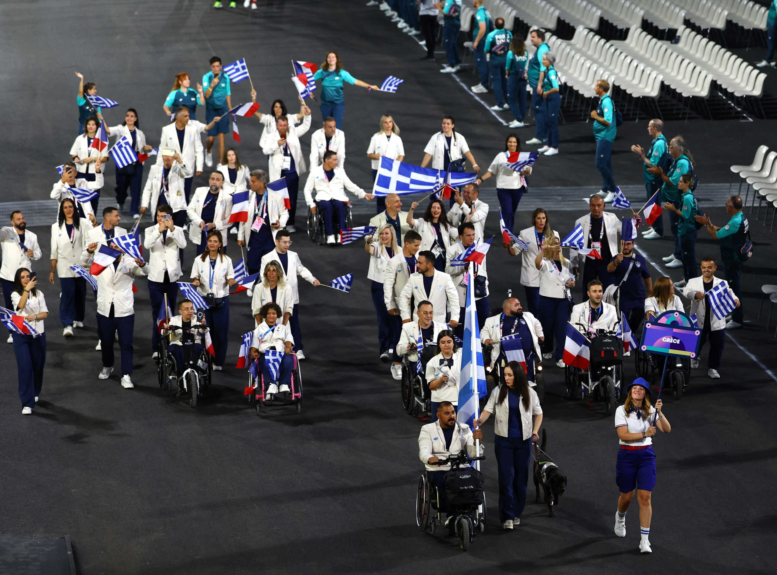 Paris 2024 Paralympics - Opening Ceremony - Paris, France - August 28, 2024 Theodora Paschalidou of Greece and Emmanouil Stefanoudakis of Greece lead their contingent during the opening ceremony REUTERS
