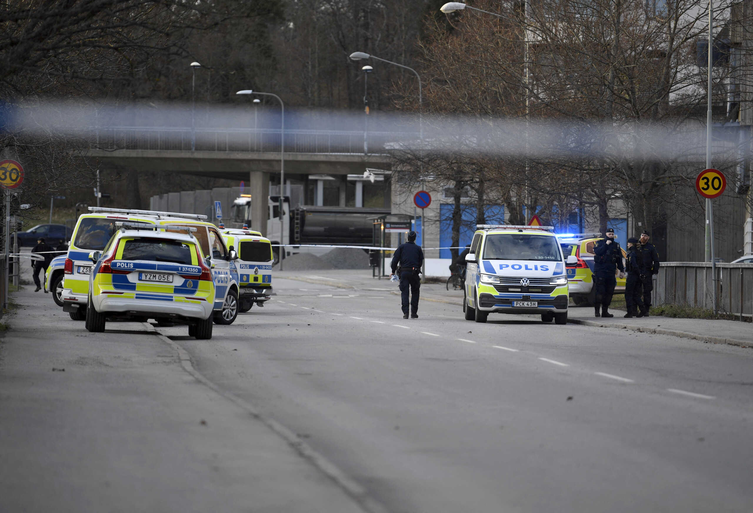FILE PHOTO: Police officers work on the scene after a person was shot and died at Skarholmen in southern Stockholm, Sweden, April 10, 2024. Oscar Olsson