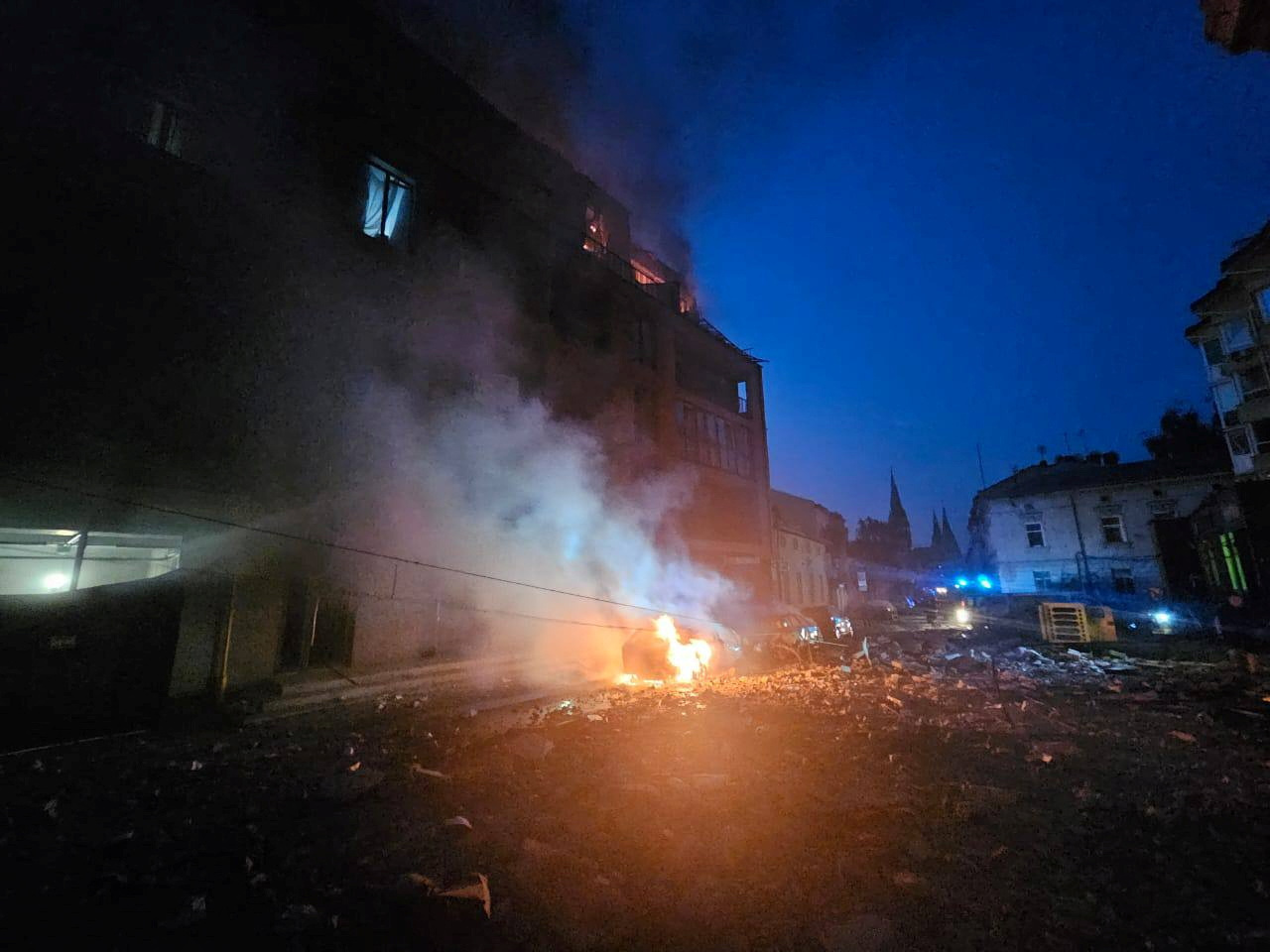 A general view shows a residential building and burning cars damaged during Russian missile and drone strikes, amid the Russia-Ukraine conflict, in Lviv, Ukraine September 4, 2024.  Mayor of Lviv City Andrew Sadovyi via Telegram