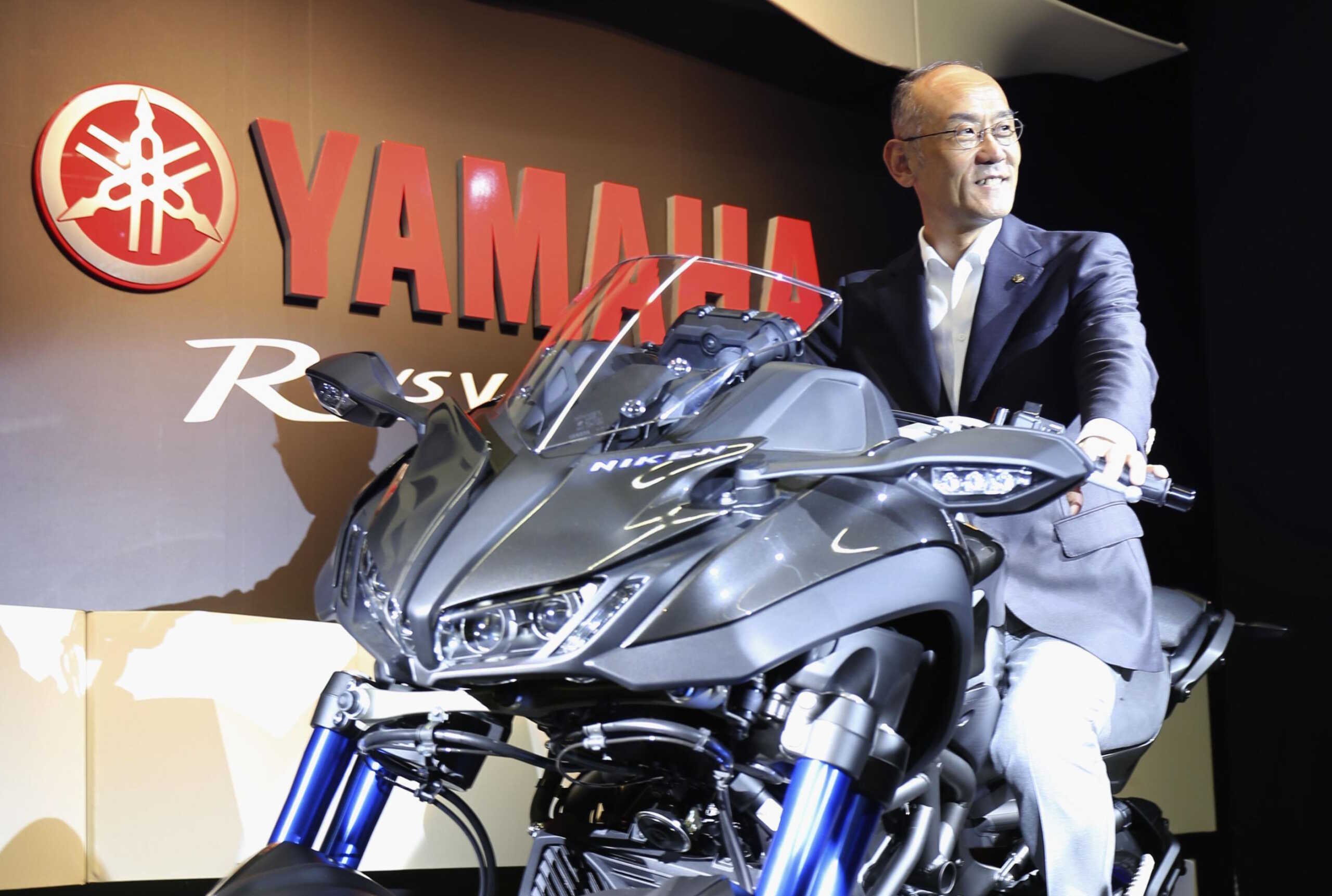 Yamaha Motor Co. President Yoshihiro Hidaka poses with NIKEN, a dual front-wheel motorcycle called leaning multi-wheeler, at an event in Tokyo on Sept. 13, 2018. (Kyodo via AP Images) ==Kyodo