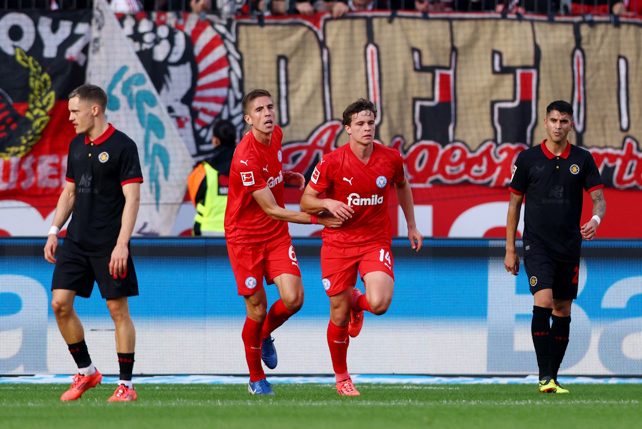 Soccer Football - Bundesliga - Bayer Leverkusen v Holstein Kiel - BayArena, Leverkusen, Germany - October 5, 2024 Holstein Kiel's Max Geschwill celebrates scoring their first goal with Marko Ivezic REUTERS