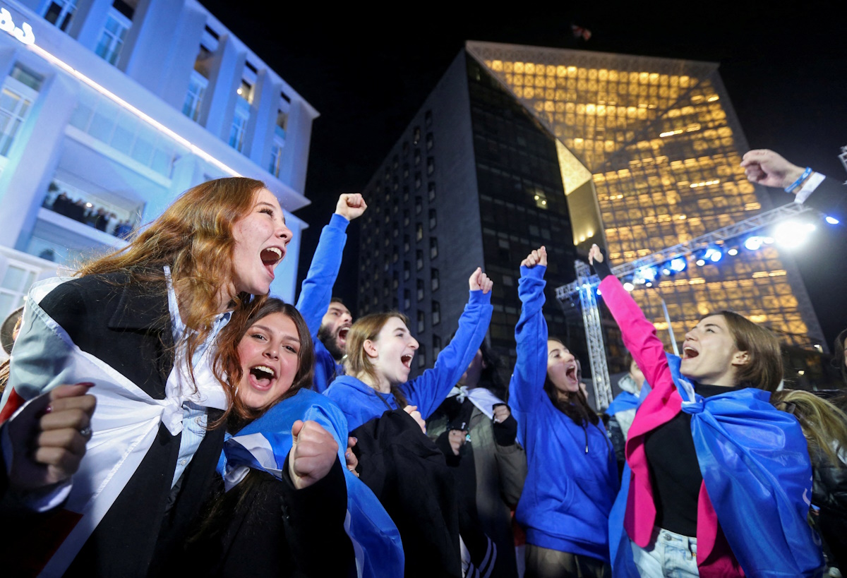 Supporters of the Georgian Dream party celebrate at the party's headquarters after the announcement of exit poll results in parliamentary elections, in Tbilisi, Georgia October 26, 2024. REUTERS