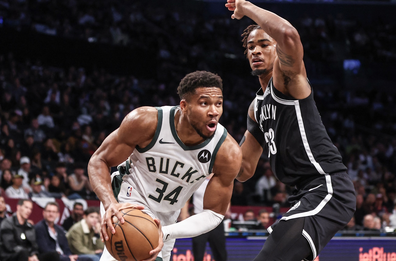 Oct 27, 2024; Brooklyn, New York, USA;  Milwaukee Bucks forward Giannis Antetokounmpo (34) looks to drive past Brooklyn Nets center Nic Claxton (33) in the second quarter at Barclays Center. Mandatory Credit: Wendell Cruz-Imagn Images
