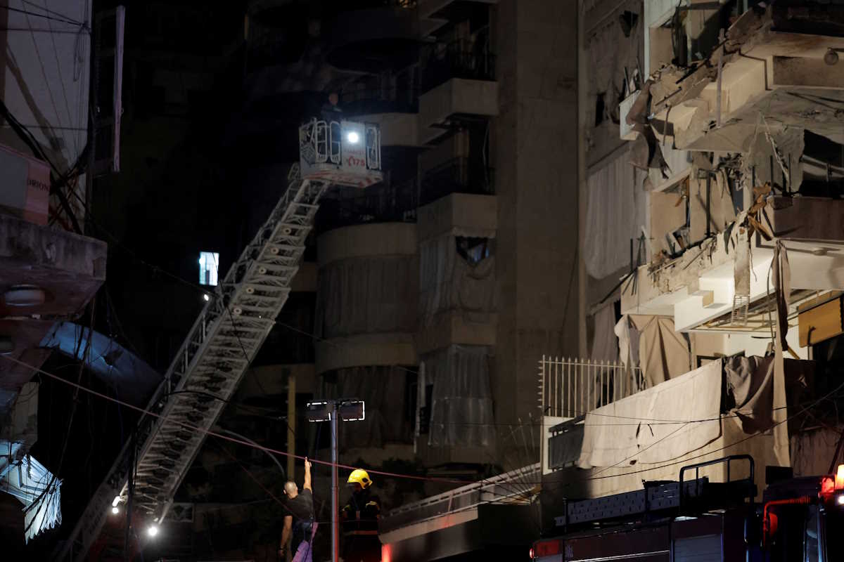 A rescue worker stands next to a damaged building at the site of an Israeli air strike, amid ongoing hostilities between Hezbollah and Israeli forces, in Ras Al- Nabaa, in Beirut, Lebanon, October 10, 2024. REUTERS