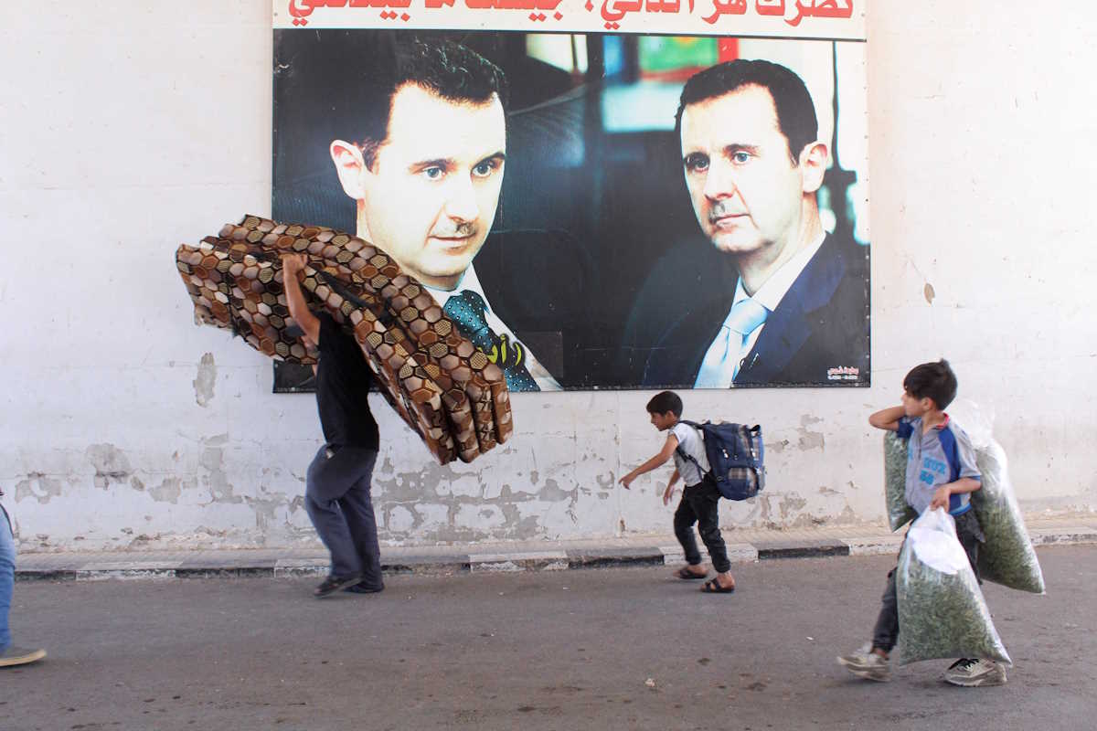 Syrians, who were living in Lebanon and returned to Syria due to ongoing hostilities between Hezbollah and Israeli forces, carry belongings at the Jusiyah border crossing, at the Syrian-Lebanese border, Syria October 2, 2024. REUTERS