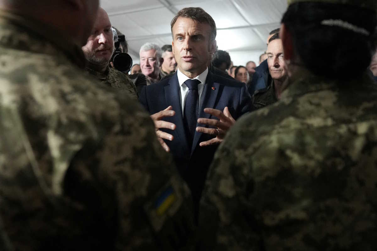 French President Emmanuel Macron speaks with Ukrainian soldiers at a military camp in eastern France, Wednesday, Oct. 9, 2024. Macron meets for the first time with some of the nearly 15,000 Ukrainian troops that France has trained for the country's fight against the Russian invasion.     Thibault Camus