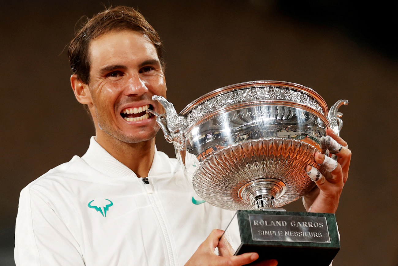 FILE PHOTO: Tennis - French Open - Roland Garros, Paris, France - October 11, 2020 Spain’s Rafael Nadal celebrates with the trophy after winning the French Open final against Serbia’s Novak Djokovic REUTERS