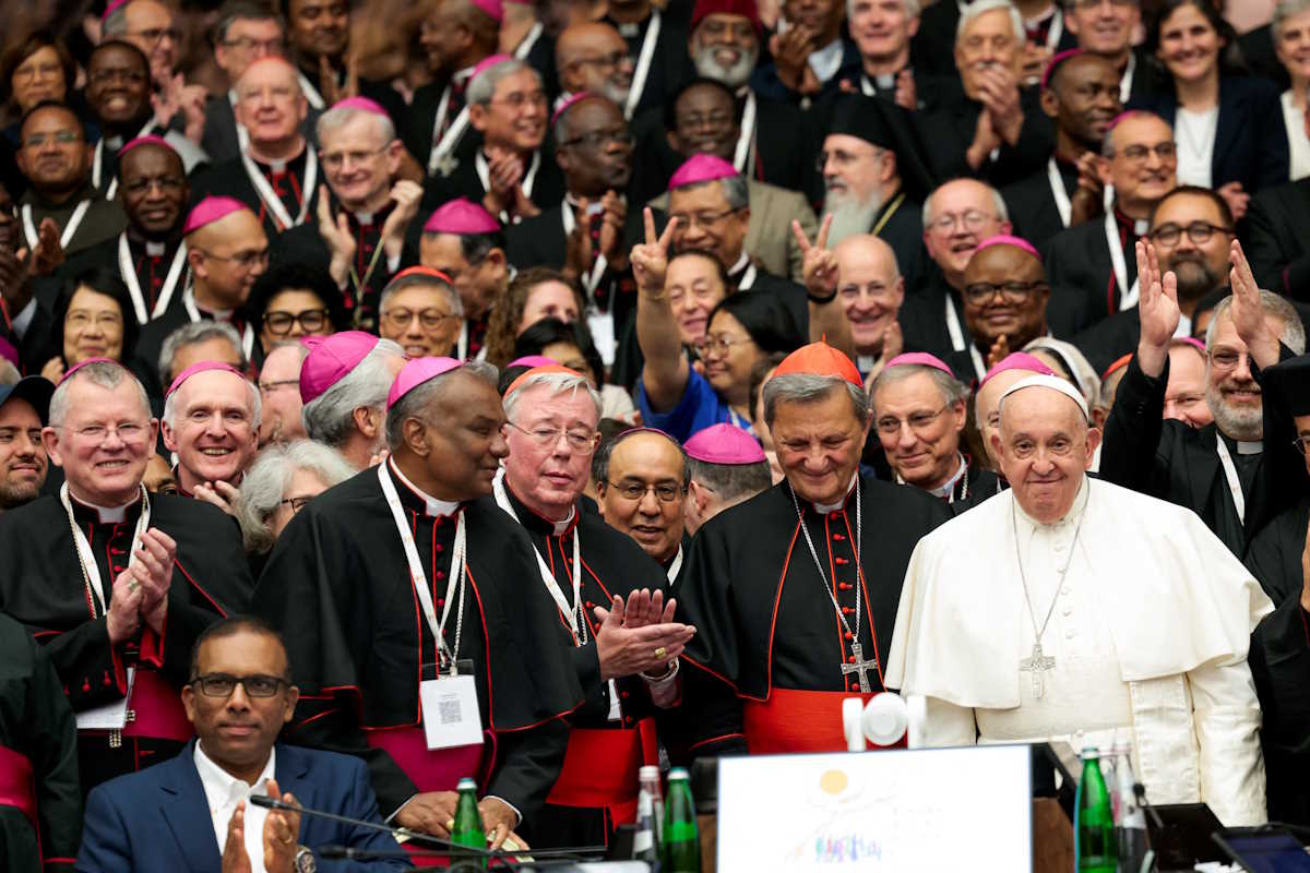 Pope Francis and clergy members pose for a photo at the Synod of Bishops at the Paul VI hall at the Vatican, October 26, 2024. REUTERS