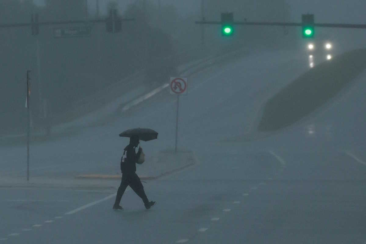 A man walks down an avenue as Hurricane Milton approaches, in Orlando, Florida, U.S., October 9, 2024. REUTERS