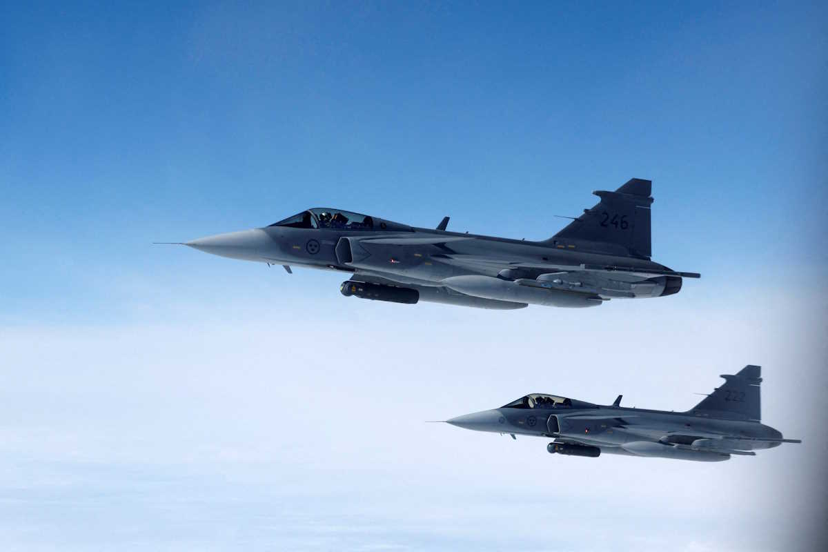 FILE PHOTO: Swedish Air Force Saab JAS 39 Gripen fighter jets fly alongside an aircraft simulating aerial interceptions, during a media day illustrating how NATO Air Policing safeguards the Allies' airspace in the northern and northeastern region of the Alliance, July 4, 2023. REUTERS