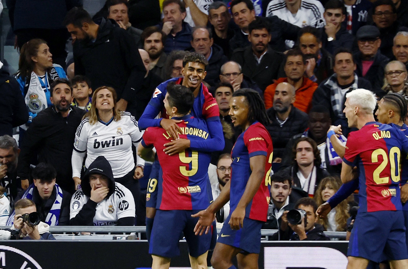 Soccer Football - LaLiga - Real Madrid v FC Barcelona - Santiago Bernabeu, Madrid, Spain - October 26, 2024 FC Barcelona's Lamine Yamal celebrates scoring their third goal with teammates REUTERS
