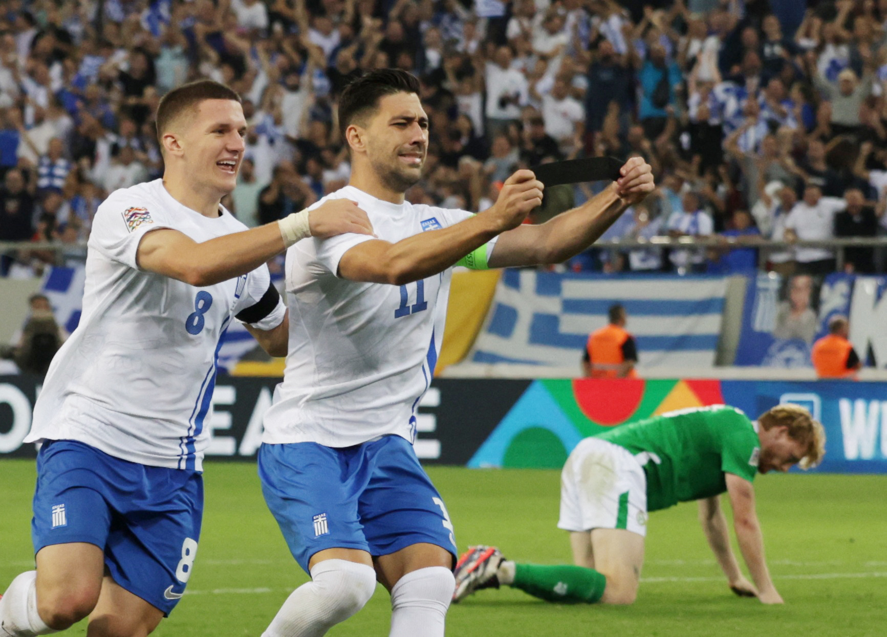 Soccer Football - UEFA Nations League - Group B2 - Greece v Ireland - Karaiskakis Stadium, Piraeus, Greece - October 13, 2024 Greece's Anastasios Bakasetas celebrates scoring their first goal with his black armband in honour of the passing of former teammate George Baldock REUTERS