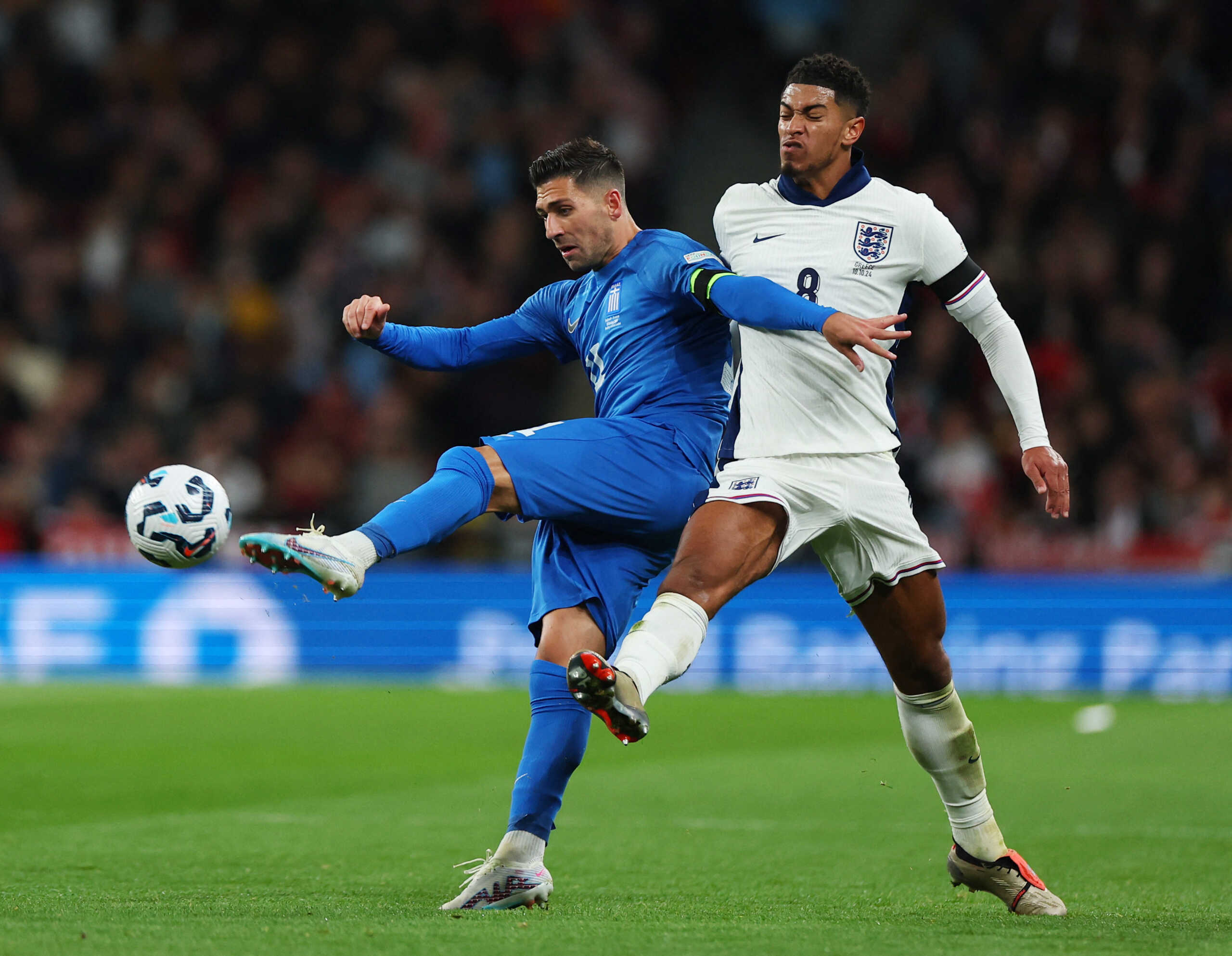 Soccer Football - UEFA Nations League - Group B2 - England v Greece - Wembley Stadium, London, Britain - October 10, 2024 Greece's Anastasios Bakasetas in action with England's Jude Bellingham REUTERS