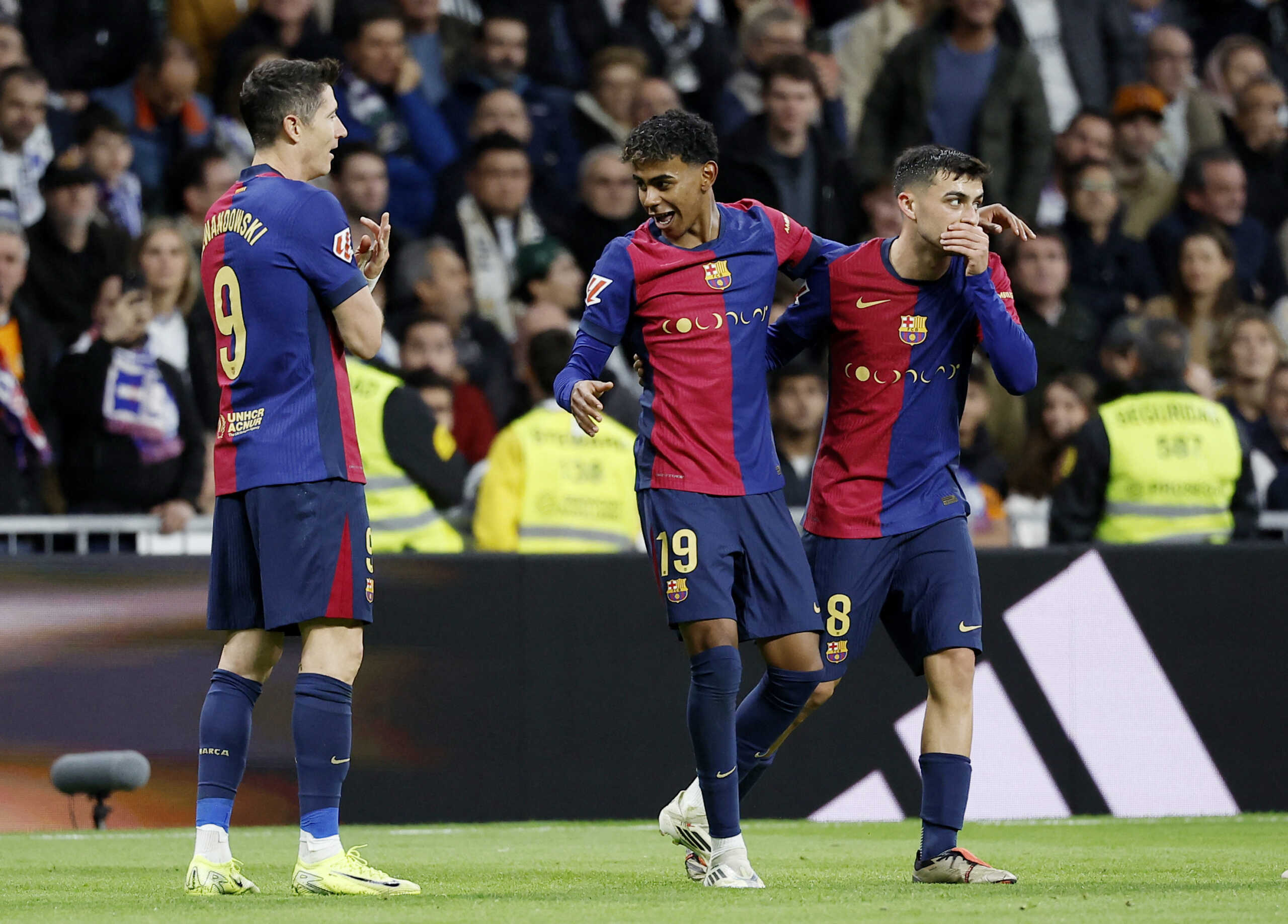 Soccer Football - LaLiga - Real Madrid v FC Barcelona - Santiago Bernabeu, Madrid, Spain - October 26, 2024 FC Barcelona's Lamine Yamal celebrates scoring their third goal with Pedri and Robert Lewandowski REUTERS