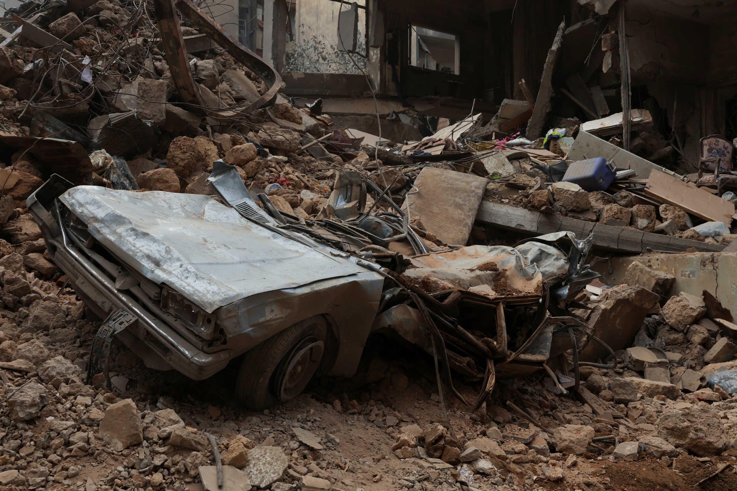 A view shows a damaged car and debris at a site of an Israeli strike, amid ongoing hostilities between Hezbollah and Israeli forces, in Beirut, Lebanon, October 12, 2024. REUTERS