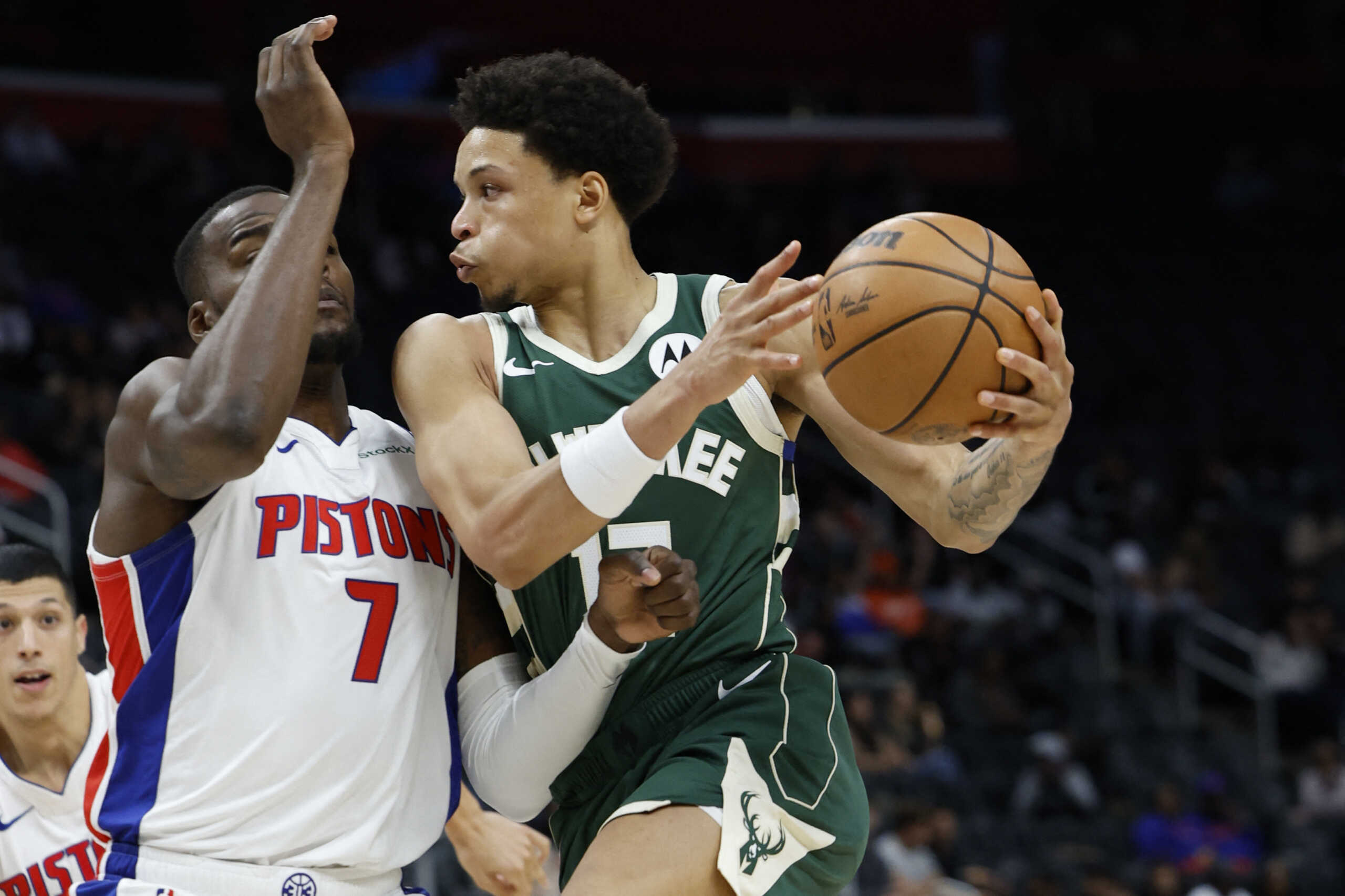 Oct 6, 2024; Detroit, Michigan, USA;  Milwaukee Bucks guard Stanley Umude (17) is defended by Detroit Pistons forward Paul Reed (7) in the second half at Little Caesars Arena. Mandatory Credit: Rick Osentoski-Imagn Images