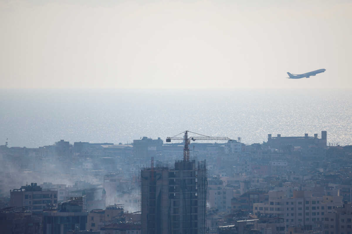 A plane takes off as smoke from an Israeli strike billows near Beirut's Rafic Hariri International Airport, amid the ongoing hostilities between Hezbollah and Israeli forces, in Beirut, Lebanon, October 5, 2024. REUTERS