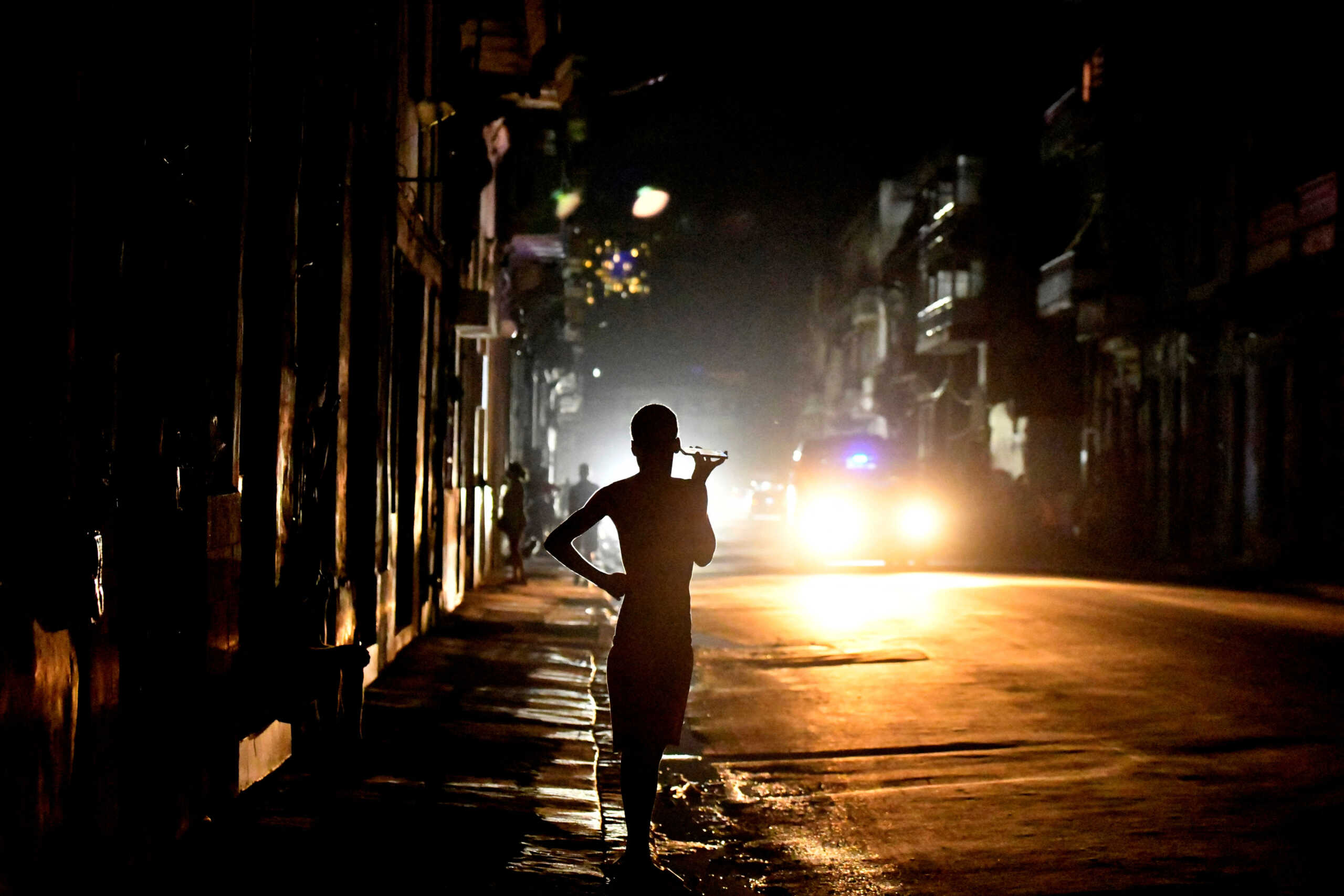 People stand in the street at night as Cuba is hit by an island-wide blackout, in Havana, Cuba, October 18, 2024. REUTERS