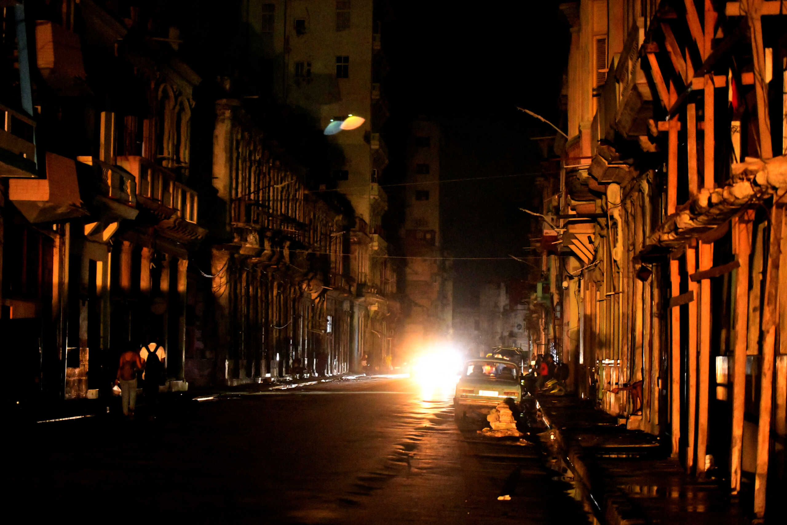 People walk in the street at night as Cuba is hit by an island-wide blackout, in Havana, Cuba, October 18, 2024. REUTERS