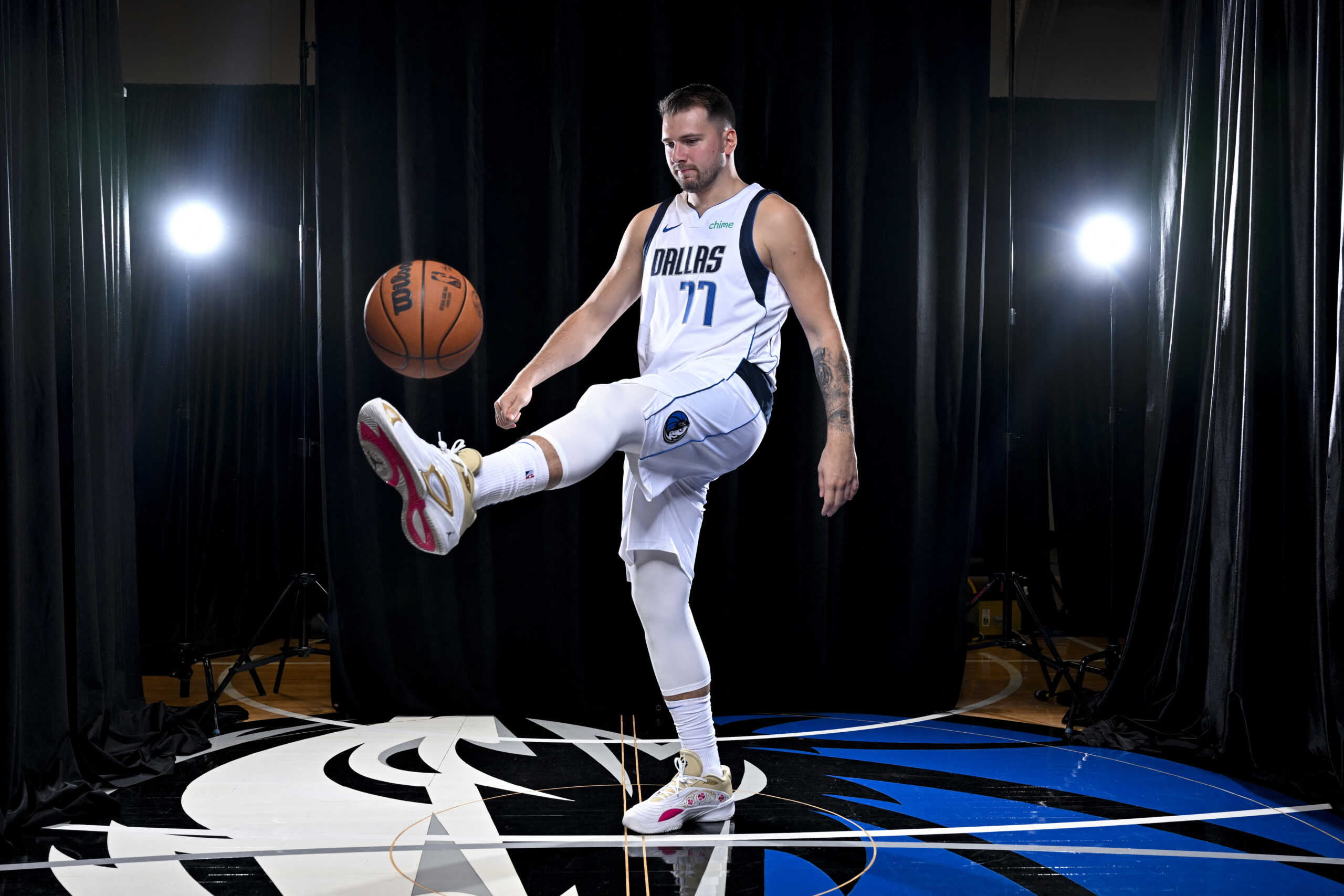 Sep 30, 2024; Dallas, TX, USA; Dallas Mavericks guard Luka Doncic (77) dribbles the basketball in soccer style as he poses for a photo during the 2024 Dallas Mavericks media day. Mandatory Credit: Jerome Miron-Imagn Images