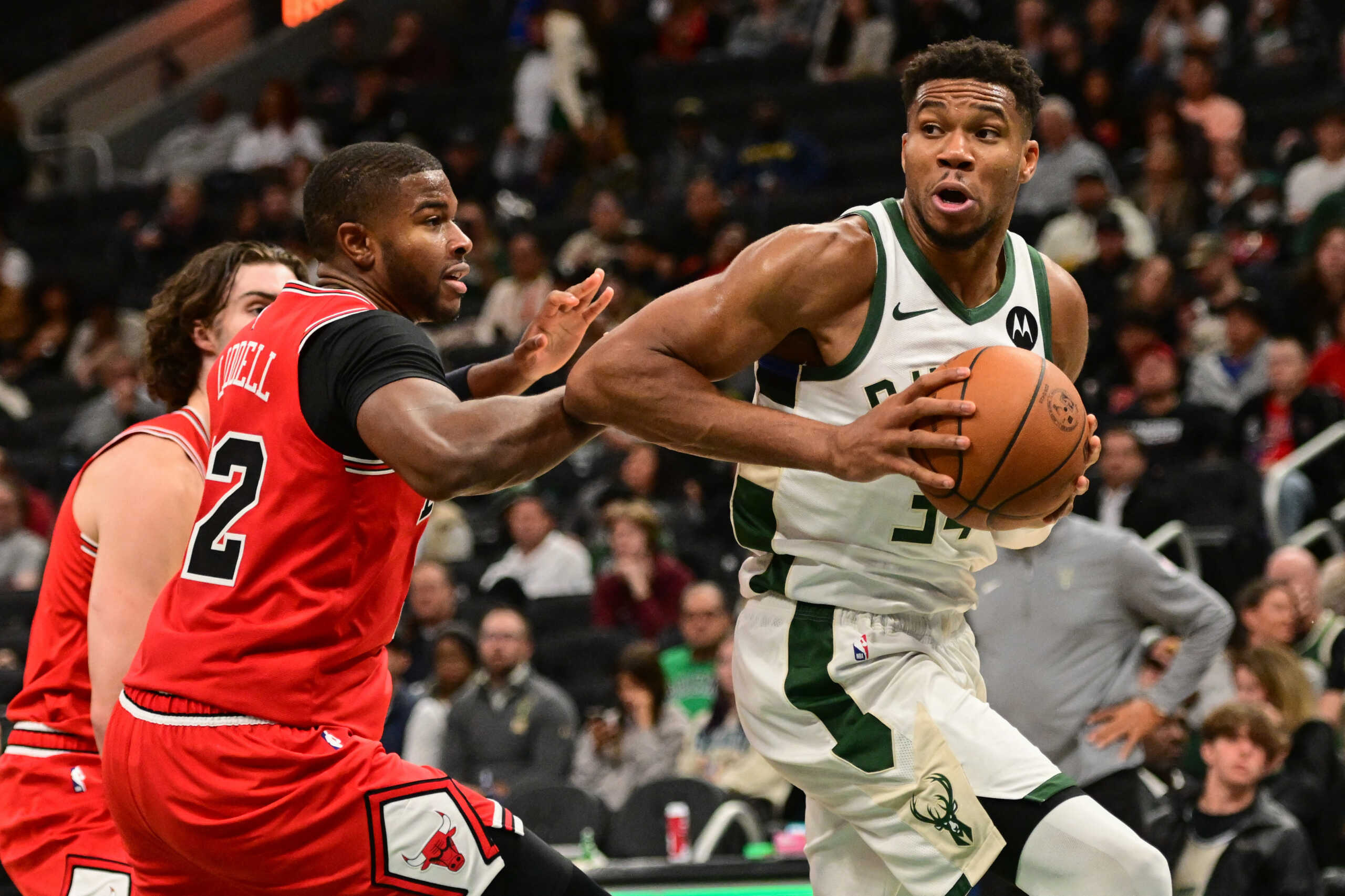 Oct 14, 2024; Milwaukee, Wisconsin, USA;  Milwaukee Bucks forward Giannis Antetokounmpo (34) drives past Chicago Bulls forward E.J. Liddell (32) in the third quarter at Fiserv Forum. Mandatory Credit: Benny Sieu-Imagn Images