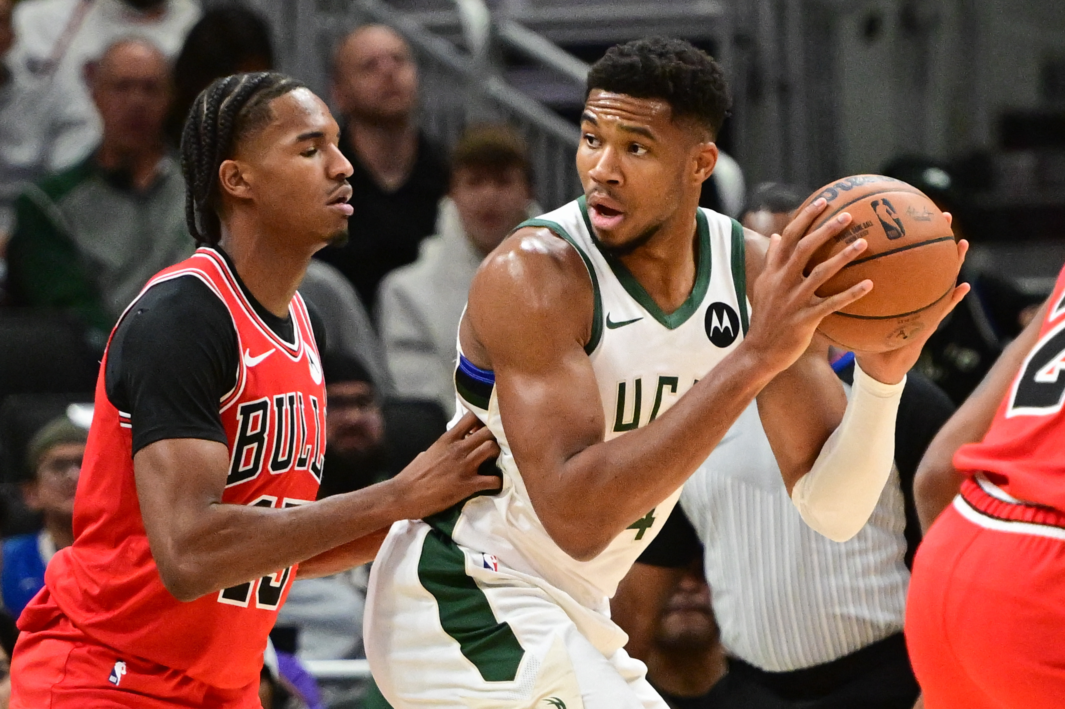 Oct 14, 2024; Milwaukee, Wisconsin, USA; Milwaukee Bucks forward Giannis Antetokounmpo (34) is guarded by Chicago Bulls guard Dalen Terry (25) in the first quarter at Fiserv Forum. Mandatory Credit: Benny Sieu-Imagn Images