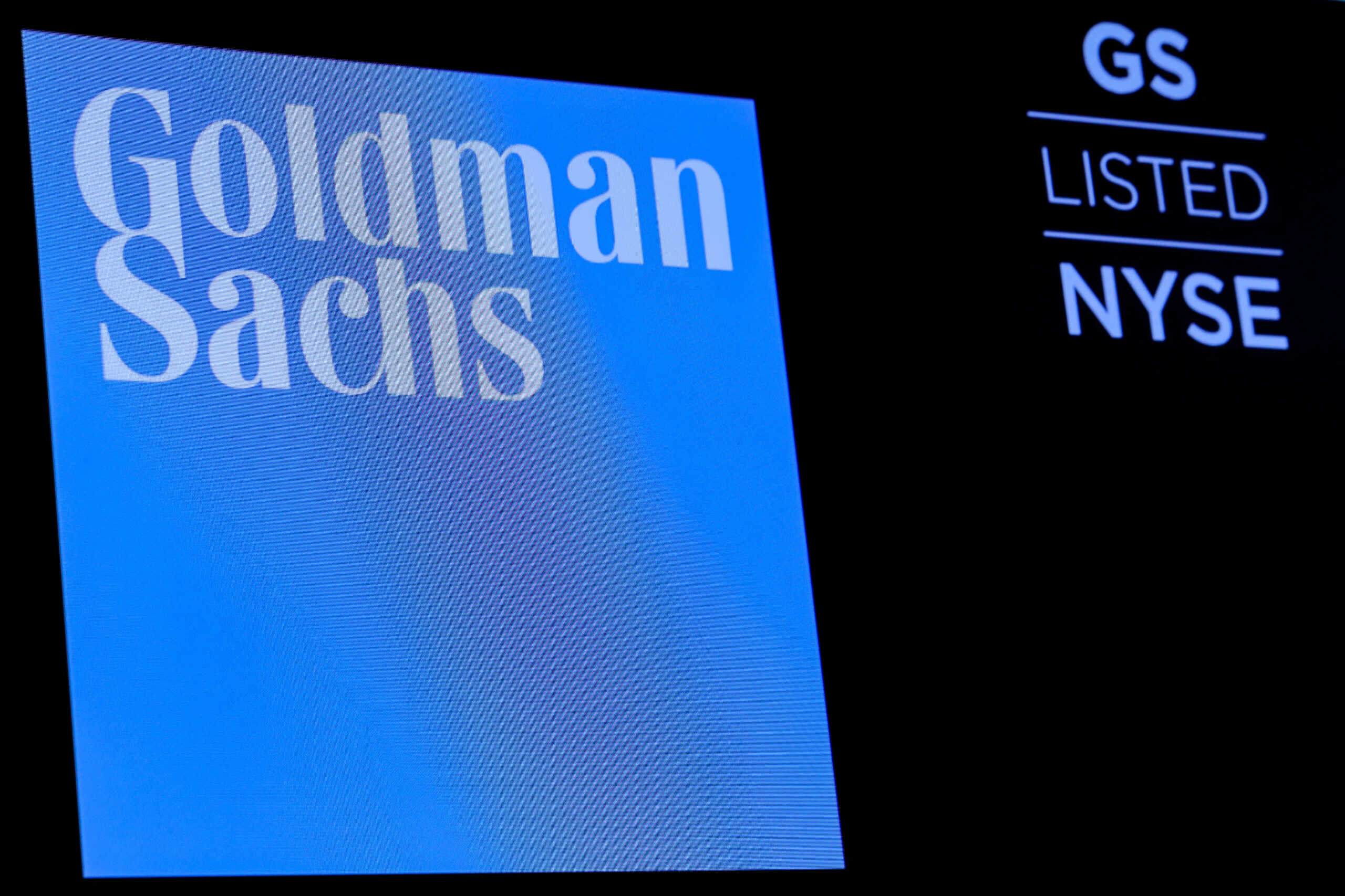 FILE PHOTO: The ticker symbol and logo for Goldman Sachs is displayed on a screen on the floor at the New York Stock Exchange (NYSE) in New York, U.S., December 18, 2018. REUTERS