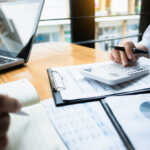 business audits using a calculator financial data investment fund at a workplace, wealth concept
