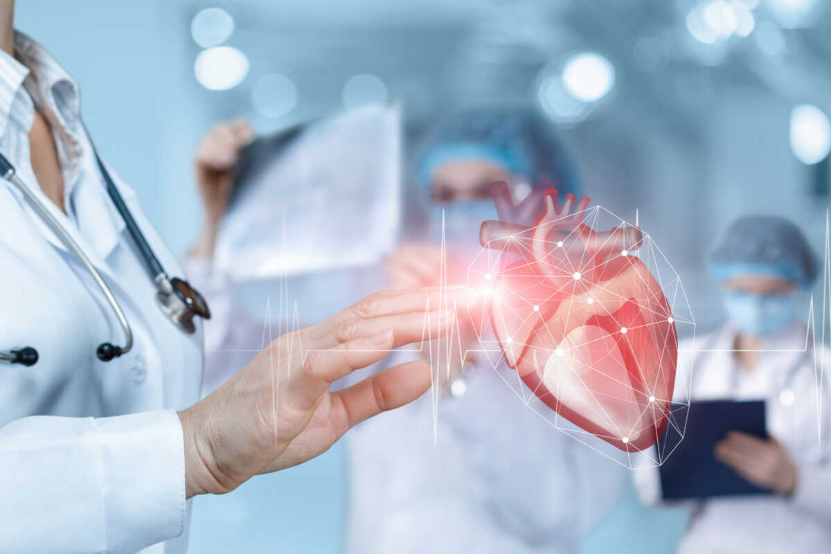 Doctor clicks on a heart with a pulse on a blurred background.