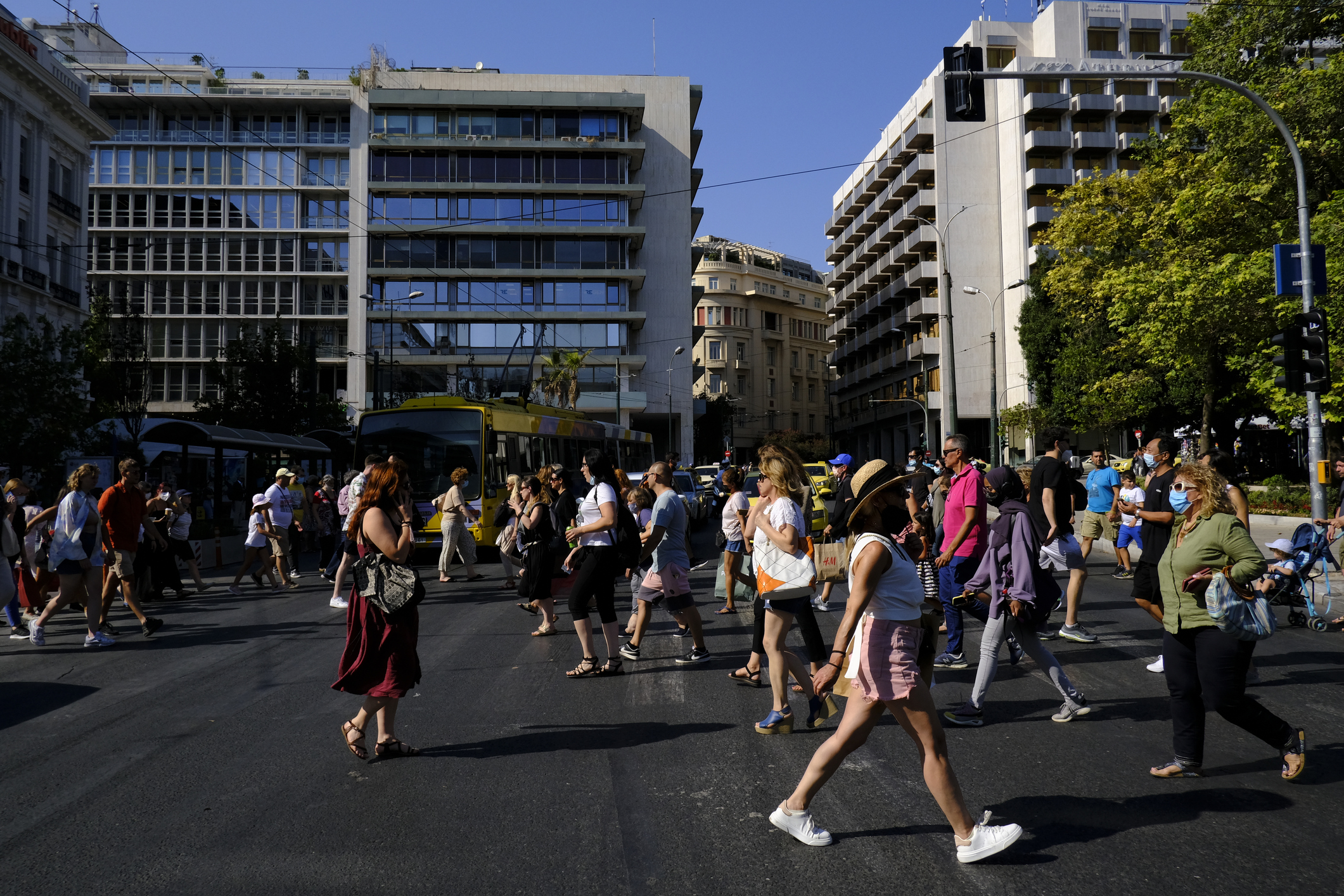 Crowd of people pass from pedestrians line during a hot day in central Athens, Greece on July 23, 2021.