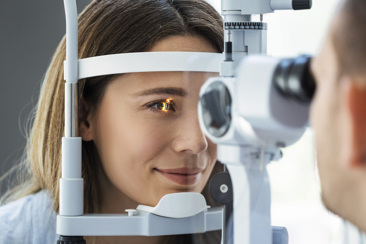 Beautiful young girl checking the eye vision in modern ophthalmology clinic